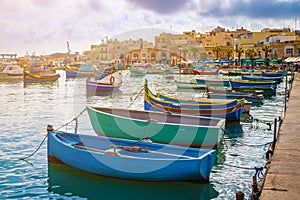 Marsaxlokk, Malta - Traditional colorful maltese Luzzu fisherboats at the old village of Marsaxlokk with turquoise sea water