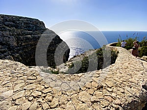 Marsaxlokk, Malta - 10-24-22 - Winding stone wall and walking path along the ocean