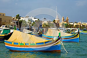 Marsaxlokk market with traditional colorful fishing boats, Malta