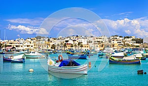 Marsaxlokk village with traditional colorful fishing boats Luzzu