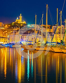 Marseille, France at night. The famous european harbour view on the Notre Dame de la Garde