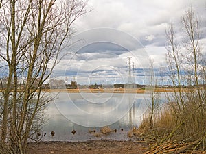 marsh of Groot Rietveld park with wind turbines and electricity pylons photo