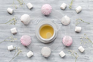 Marsh-mallow and tea for woman breakfast concept on wooden background top view