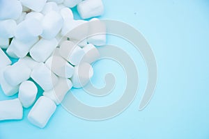 White small Marshmallow on a blue background