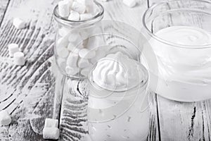 Marshmallow creme in glass jars photo
