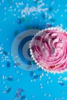 Marshmallow cupcake on blue background