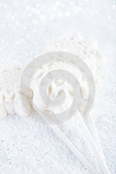 Marshmallow lolly snowflake on white festive backround