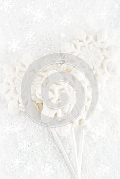 Marshmallow lolly snowflake on white festive backround