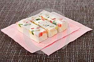 Marshmallow with marmalade on pink paper napkin on mat