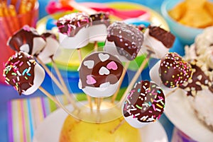 Marshmallow pops with chocolate and colorful sprinkles