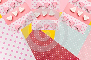 Marshmallow in a row of hearts. Pink and white candies on colored background