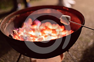 Marshmallow on a stick being roasted