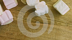 Marshmallow on the table. Christmas atmosphere with lights in the background