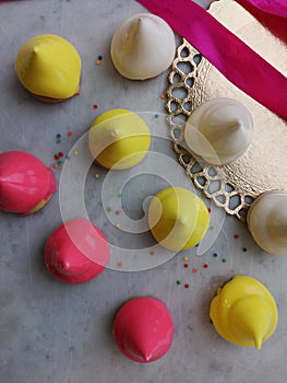 Marshmallow white, yellow, pink on a marble board