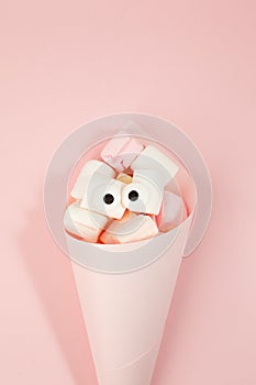 Marshmallows with eyes in paper cone. Funny kawaii emoji face. Cute cartoon character. Minimal summer flat lay design. Sweet food