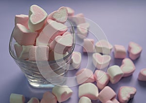 marshmallows in the shape of a heart. on a purple background (veri peri), mockup, top and side view.