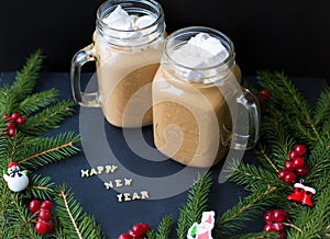 Marshmellou cocoa, Christmas tree with decorations on a black background. The inscription Happy New Year