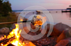Marshmallow on fire during summer front lake