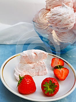 Marshmellows in a bowl on blue background