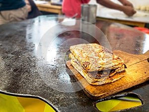 Martabak Telor or Stuffed Omelette Pancake Fried Bread. A Traditional Minang or Padang Cuisine on Flat Frying Pan