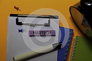 Martech write on sticky notes. Isolated on orange table background photo