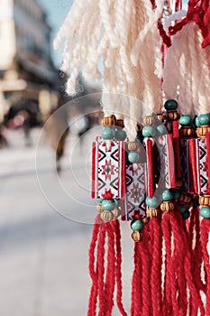 Martenitsa and blurred street of the city of Plovdiv, Bulgaria. Traditional spring celebration in Romania and Bulgaria