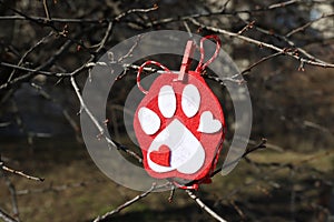 Martenitsa on a branch in shape of dog paw, dog love