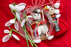 Martenitsa - traditional Bulgarian custom - red background with snowdrops