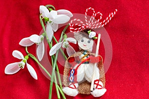 Martenitsa - traditional Bulgarian custom - red background with snowdrops