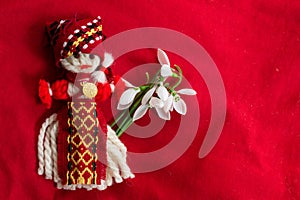 Martenitsa - traditional Bulgarian custom - red background with snowdrops