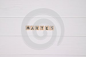 Martes week day name on white wooden background photo