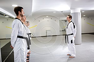 Martial art master lining up his taekwondo students