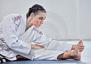 Martial arts, fitness and stretching with woman in karate school for training, sports and fight performance. Strong