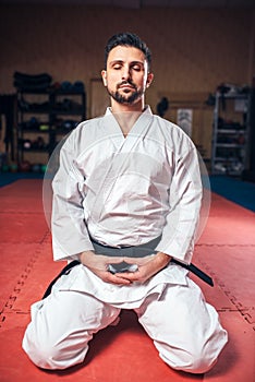 Martial arts, man in white kimono with black belt