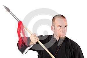 Martial arts teacher with spear in defensive pose