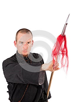 Martial arts teacher with spear in fighting pose