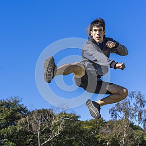 martial fighter practicing flying kicks