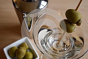 Martini with bowl of olives and drink shaker