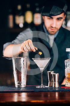 Martini, classic cocktail with olives, vodka and gin served cold in restaurant, pub or bar