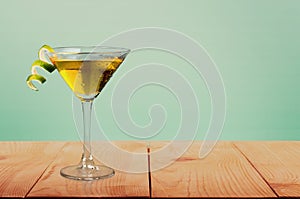 Martini cocktail in glass on wooden table