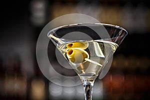 Martini cocktail with green olives