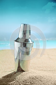 Martini cocktail shaker on the beach