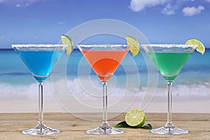 Martini Cocktails in glasses on the beach with lemons