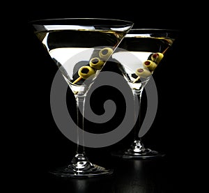 Martini cocktails with olives isolated on black