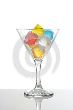 Martini glass with colorful plastic ice cubes