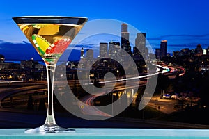 Martini glass with dibs against city skyline