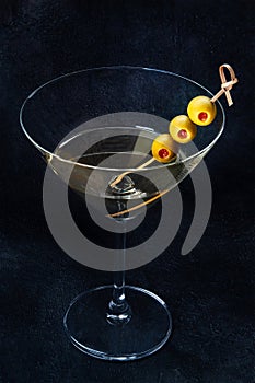 Martini. A glass of dirty martini cocktail with vermouth and olives