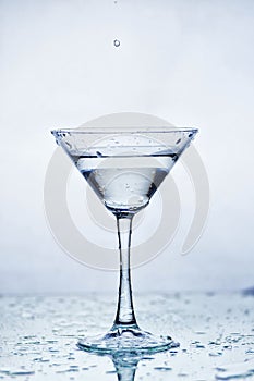 Martini glass with frozen splashing drops of drink