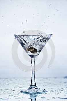 Martini glass with frozen splashing drops of drink