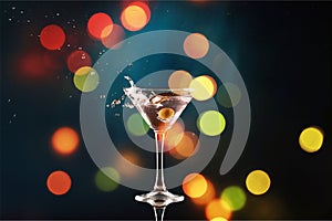 Martini in glass with olives on bokeh background